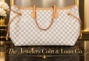 A Louis Vuitton Damier Azur Neverfull Bag with The Jewelers Coin & Loan Co. Logo across the bottom. They also buy silverware sets, estate jewelry, and luxury watches like Rolex, Patek Philippe, Omega and high-end gold jewelry, designer jewelry and numismatic coins.