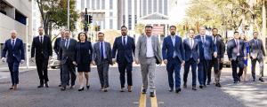 Campione Law team members in business attire walking together on a city street.