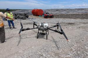Technicians test the UAV before conducting a spraying operation at the Da Phuoc Integrated Waste Management Facility.