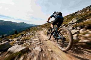 Person cycling along mountain track