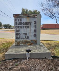Before photo of the weathered Eye Surgery Center of North Dallas monument sign in Carrollton, Texas