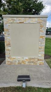 Renovated stone monument sign with blank prepared sign panel at an eye surgery center in Carrollton Texas
