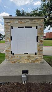 Monument sign with masked sign panel prepared for new lettering installation