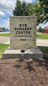 Renovated monument sign showing new black dimensional Eye Surgery Center lettering