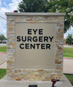 Front view of completed Eye Surgery Center monument sign with dimensional black lettering