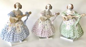 Herend porcelain set showing three girls playing guitar dressed in blue, pink and green, all three colors of the Deryne (Mrs. Dery or Lady Dery) collection. Estimate: $1,000-$1,200
