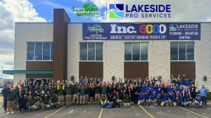 Lucia Landscaping and Lakeside Pro Services team gathers outside their Roseville, Michigan, headquarters beneath a banner celebrating both companies’ 2026 Inc. 5000 recognition.