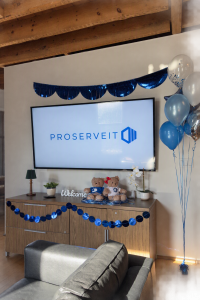 ProServeIT welcome area featuring company branding on a television screen, office decorations, balloons and welcome displays during the open house at the new Mississauga office.