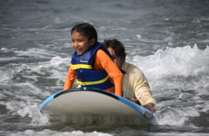 Learning to surf with the help of Corky Carroll's Surf School instructor