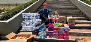 Better Off Home Buyers founder Scott Dalinger and his family with donated earthquake relief supplies in Colombia.