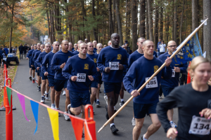 Runners carry a law enforcement department flag during the 2025 Connecticut Law Enforcement Officers Memorial Run.