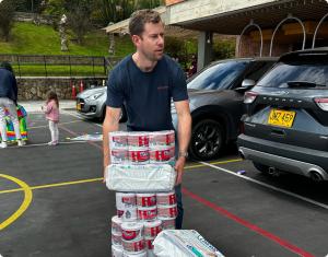 Scott Dalinger carrying donated toilet paper and hygiene supplies for earthquake relief efforts in Colombia.