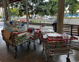 Shopping carts filled with bulk emergency relief supplies for Colombian earthquake victims.