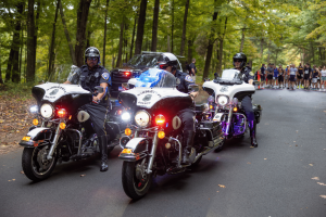 Police motorcycles lead a large group of runners at the 2024 Connecticut Law Enforcement Officers Memorial Run.
