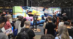Greg Meyers of ForgeFX Simulations speaks to attendees beside a video wall showing an enterprise XR training simulation.