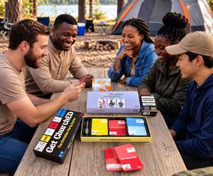 Friends playing KultureGames Christian games with four game boxes on the table