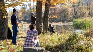 Students at Princeton Seminary's Farminary overlooking a pond.