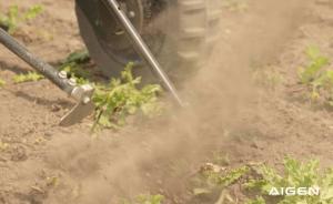 Aigen Element robot's weeding arm uprooting weeds in farm soil.