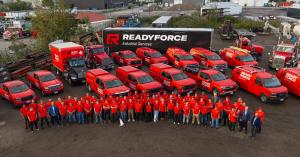 Aerial photo of the ReadyForce Industrial Services team in red shirts with their fleet of branded red trucks and vans