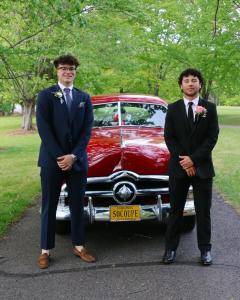 Cash Gaudio posing in front of a classic car with friend Terry White
