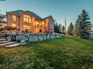 Two-story custom home at dusk with landscaped yard, Salt Lake County, Utah