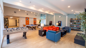 Spacious indoor lounge area with games, billiards, foosball and seating