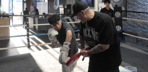 Coach Al working with men;s skills boxing member