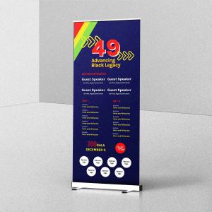 A navy blue retractable banner with a red, yellow, and green diagonal stripe, reading "49: Advancing Black Legacy" for the Whitney M. Young Jr. Memorial Conference, with keynote speaker slots, a two-day schedule, a December 3 gala date, and sponsor logo p