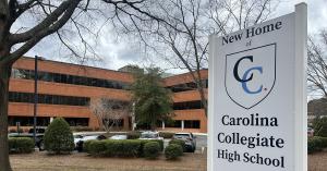 Exterior of Carolina Collegiate High School in Durham, North Carolina, with the school sign in the foreground.