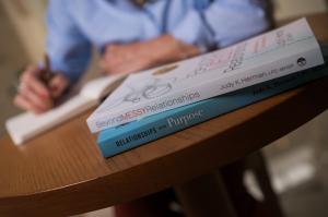 Copies of Judy K. Herman’s books “Beyond Messy Relationships” and “Relationships With Purpose” stacked on a table.