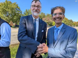 Hiten Bhuta standing with a community leader during a Chicago-area community gathering in October 2026.