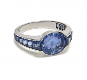 Platinum men’s ring with an antique carved Ceylon sapphire intaglio shown beside its Gübelin Gem Lab report