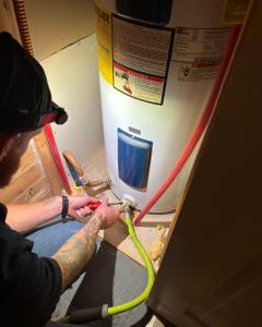 Easton Working on a Water Heater in Tulsa