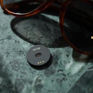 Up close photo of HIYD together with sunglasses on a green marble table