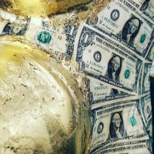 Close-up detail of genuine U.S. currency and 24-karat gold leaf covering Midas Hart’s rhinoceros sculpture Rhinos Don’t Grow on Trees.