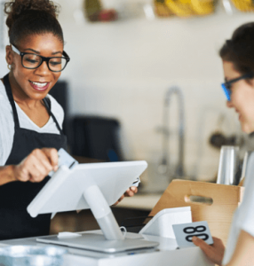 Retail business using a POS system to process a card payment at checkout, demonstrating merchant services, payment processing, customer transactions and point-of-sale technology for small businesses.