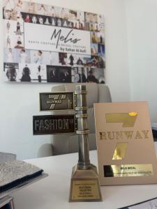 The 2026 Runway 7 Fashion Awards Best Bridal Collection trophy and finalist recognition presented to Melis Bridal. Courtesy of Melis by Sahar Al Aufi.