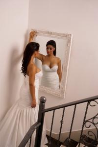 The Serena bridal gown by Melis Bridal, featuring a sculpted embellished bodice and draped silhouette. Photo by Arash Tizpa.