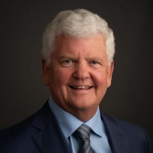 Headshot of Steve Collar, Vistage Chair in Jacksonville, smiling in a navy suit and light blue shirt