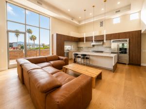 Custom modern kitchen with wood cabinetry, large island, and open living area in a Los Angeles residential conversion