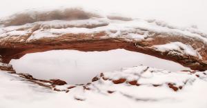 Mesa Arch in Canyonlands National Park, Utah, surrounded by fog.