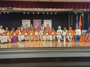 Priests and community participants holding recognition certificates on stage during HMEC 2026 in Buena Park, California.