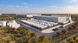 Aerial view of white data centre with blue flashes and car parking within landscaped gardens