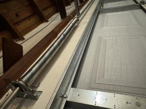 Overhead view of heavy-duty galvanized torsion springs installed during a garage door spring replacement in Downtown Long Beach, California.