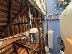 Overhead view of an older LiftMaster garage door opener motor unit undergoing gear and electrical repairs in Long Beach, California.