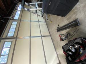 Overhead view of heavy-duty torsion springs and aircraft-grade steel cables installed during same-day garage door repair in Santa Clarita, California.