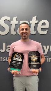 Jacob Ayubi, State Farm Insurance Agent in Ashburn, Virginia, holding his 2025 and 2026 BusinessRate awards