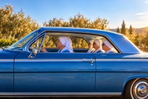 four sisters riding in a 1963 pale blue impala convertible