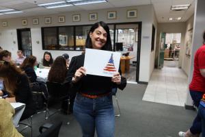 Image of an employee holding a greeting card