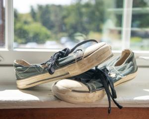 A worn pair of dark canvas sneakers sits on a windowsill inside the office of OneQuest Health Chief Executive Officer Rick Wurth. The shoes belonged to a young child who entered the health system's care after facing traumatic circumstances.